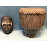 A carved African tribal style mask with painted decoration; and a skin covered antique African drum.