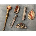 Five pieces of Scottish type silver with agate mounts - a dirk brooch, an oval scrolled pendant, a
