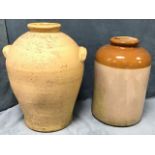 A large tapering stoneware jar with moulded handles, the base with tap hole and neck with moulded