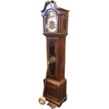 A nineteenth century mahogany longcase clock with swan-neck pediment above an arched door flanked by
