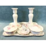 A French porcelain Limoges ladies dressing table set with a pair of candlesticks, ring stand and