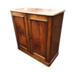 A Victorian mahogany side cabinet with rectangular rounded top above a pair of panelled doors