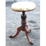 A circular Victorian rise-and-fall telescopic mahogany stool with floral upholstered seat on