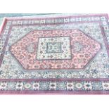 An oriental style rug woven with square floral medallion to rectangular octagonal pink flowerhead