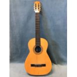 A Spanish classical guitar with nylon strings and ebonised fingerboard. (38.5in)