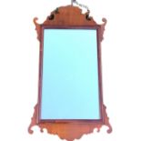 A Chippendale style mahogany mirror, the rectangular plate in cushion moulded frame with fretwork