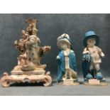 A Meissen style porcelain group with figure of plenty and winged cherub by column, with three cup