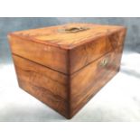 A Victorian walnut sewing box with brass military style handle to lid, the quilted lined interior