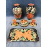 Six pieces of Maling daisy pattern lustre ware with yellow & orange flowers and green leaves