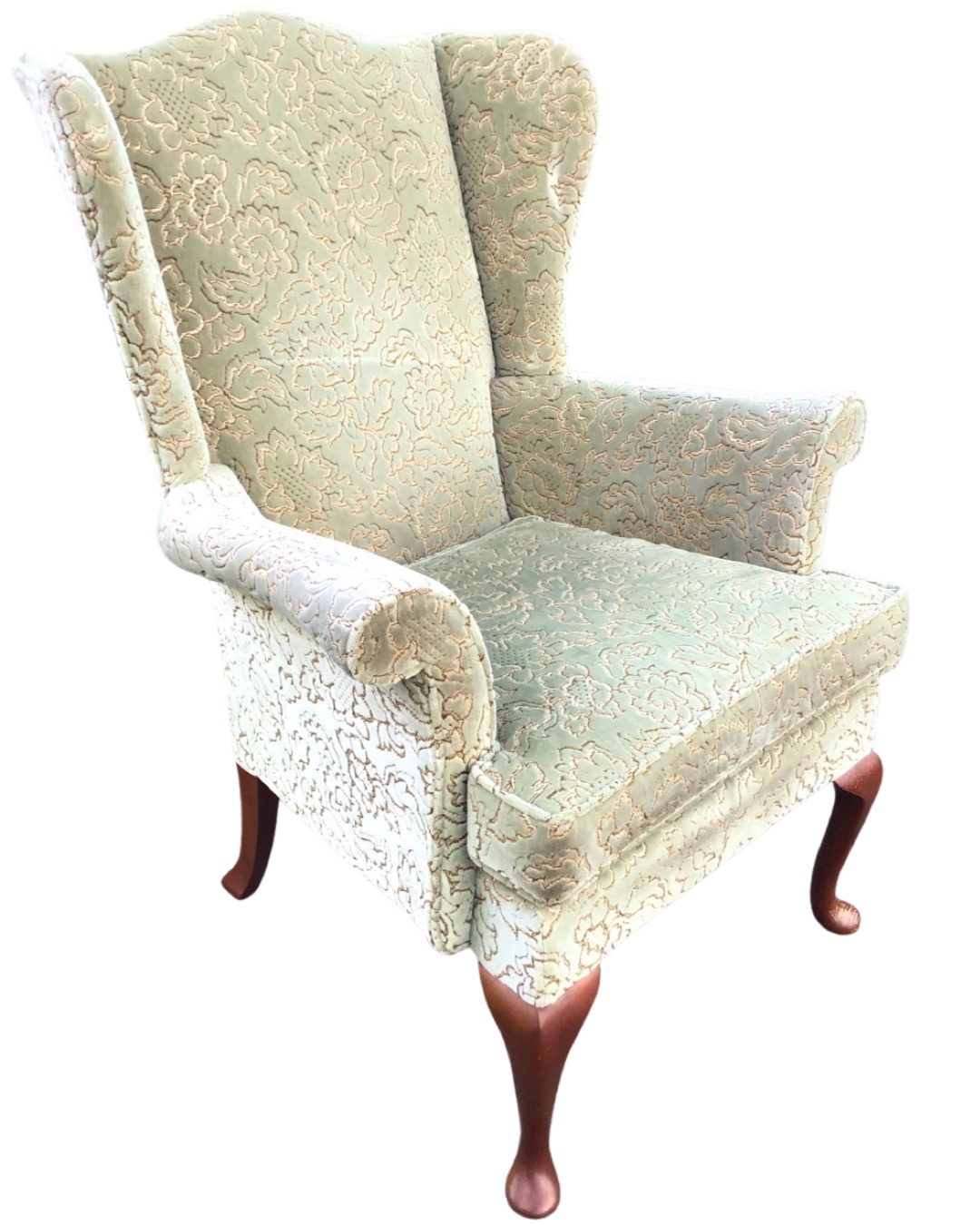 A Parker Knoll wing armchair with arched back and shaped arms framing
