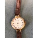 A ladies 15ct gold wristwatch, the circular enamelled dial with roman chapters signed Robinson &