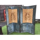 A four-fold velvet covered screen with brass studding, applied with a pair of tapestry panels