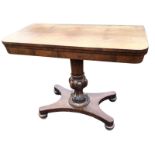 A George IV rosewood turn-over-top tea table, the twin rounded leaves on a tapering lobbed carved