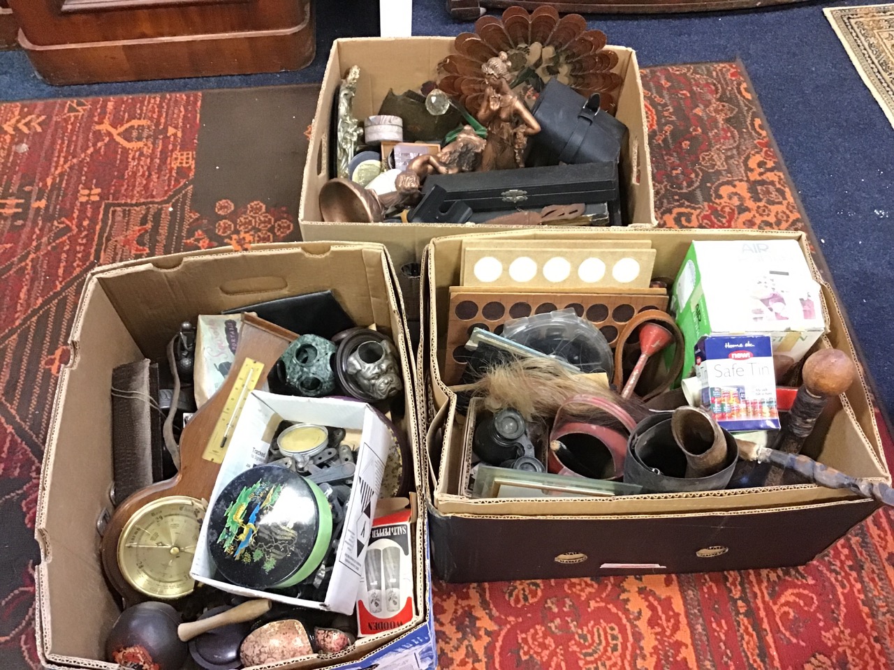 Three boxes of miscellaneous collectors items including coin trays, tin, wartime binoculars, leather