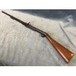 An early C20th BSA air rifle with walnut stock and underlever action, the weapon numbered 12389. (