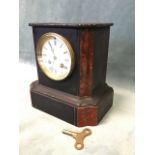 A Victorian polished slate mantle clock, the architectural style case set with shaped rouge marble