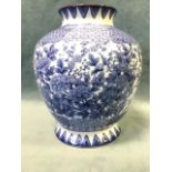 An oriental porcelain blue & white vase decorated with continuous flowers framed by lotus shaped