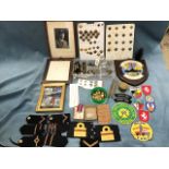 A collection of military buttons, epaulettes, fabric badges, naval, some medals, ribbons, badges, an