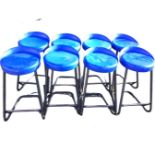 A set of eight contemporary circular cantilevered stools, with shaped seats on tubular frames & legs