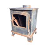 A cast iron stove of bowfronted outline with arched door, raised on splayed bracket feet - glass