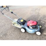 A Honda rotary garden mower with fabric grassbox, petrol engine, four adjustable wheels, etc.