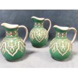 A graduated set of three Victorian WB Cobridge jugs in the Tyrol pattern, the pieces overlaid with