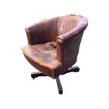 A twentieth century leather upholstered office armchair, with horseshoe shaped panelled back framing