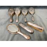 Seven hallmarked silver-backed ladies dressing table pieces, embossed with winged cherubs and