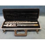 A hard cased Buescher flute - the aristicrat model with three tubular pieces.