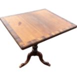 A nineteenth century snap-top mahogany occasional table, the top with laburnum banding supported