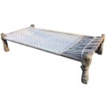 An Indian charpoy, the rectangular framed daybed with plaited string base