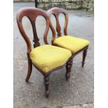 A pair of Victorian mahogany dining chairs with spade shaped backs and vase splats above stuffover