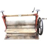 A C20th mangle with iron frame and sprung wood rollers by JA McFarlane Ltd of Glasgow, mounted on