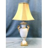 A large elegant porcelain tablelamp of vase form having gilt swan handles, the urn decorated with