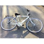 A Raleigh bicycle, the 18 speed Oakland model with Shimano revoshift gears, padded seat, panier
