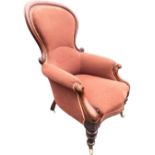 A Victorian mahogany spoonback armchair with cushion moulded scrolled frame to padded back & arms,