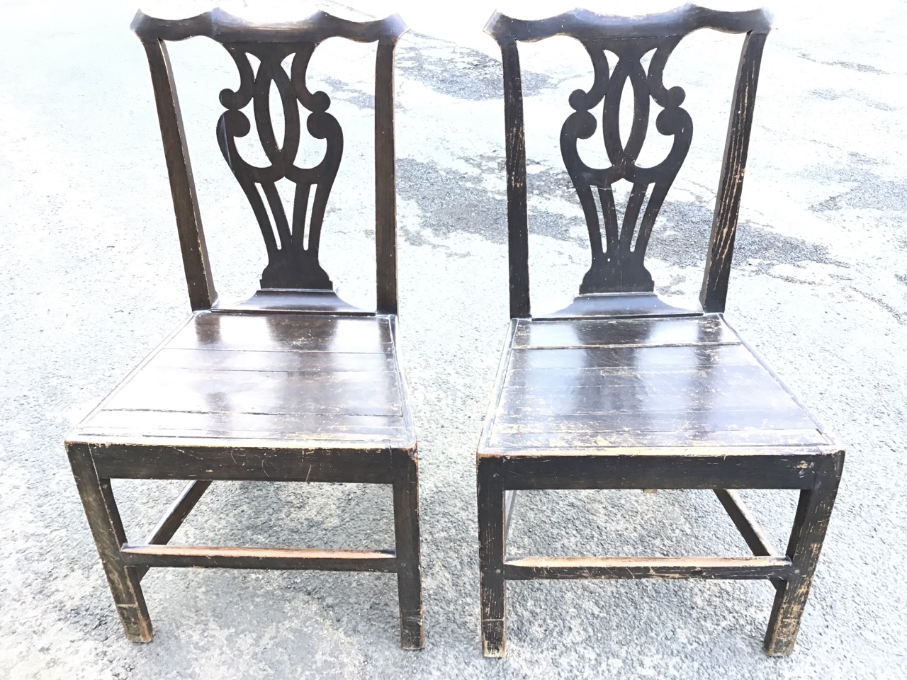 A pair of nineteenth century oak Chippendale style chairs with shaped back rails above pierced