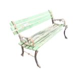A 4ft garden bench with wood slats to back & seat on cast iron scrolled supports, raised on