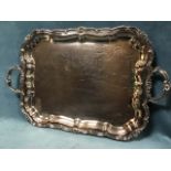 A large Victorian silver plated tray with scalloped foliate scrolled border and acanthus cast