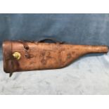 A leather shoulder of mutton gun case with brass lock and buckle, having leather strap handle. (31.