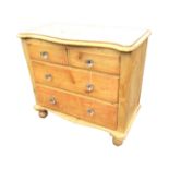 A Victorian pine chest of drawers, the moulded top of serpentine outline above two short and two