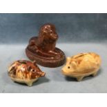 A nineteenth century salt glazed stoneware lion doorstop on oval sgraffito incised plinth; and two