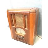 A 1930s walnut cased deco valve radio by The Pilot Radio Co, the case with speaker above oval
