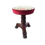 A circular George IV upholstered rise-and-fall mahogany stool with tapestry upholstered seat on leaf