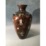 A cloisonné vase of hexagonal tapering form decorated with butterfly floral panels on speckled amber