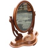 A Victorian mahogany dressing table mirror, the plate in oval frame on pierced scroll carved