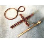 A large yellow metal crucifix mounted with oval cabochon shaped amethysts, surmounted by ring hook -