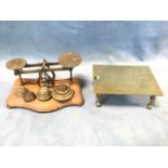 A set of Victorian oak postal scales with various sets of brass weights; and a rectangular brass