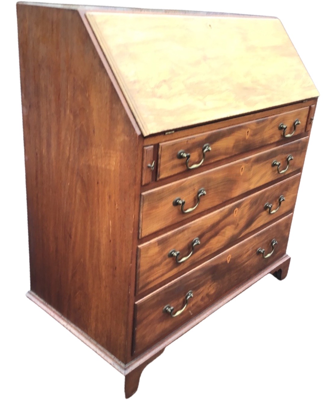 A George III style mahogany bureau, the moulded fallfront enclosing a fitted interior with central