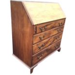 A George III style mahogany bureau, the moulded fallfront enclosing a fitted interior with central